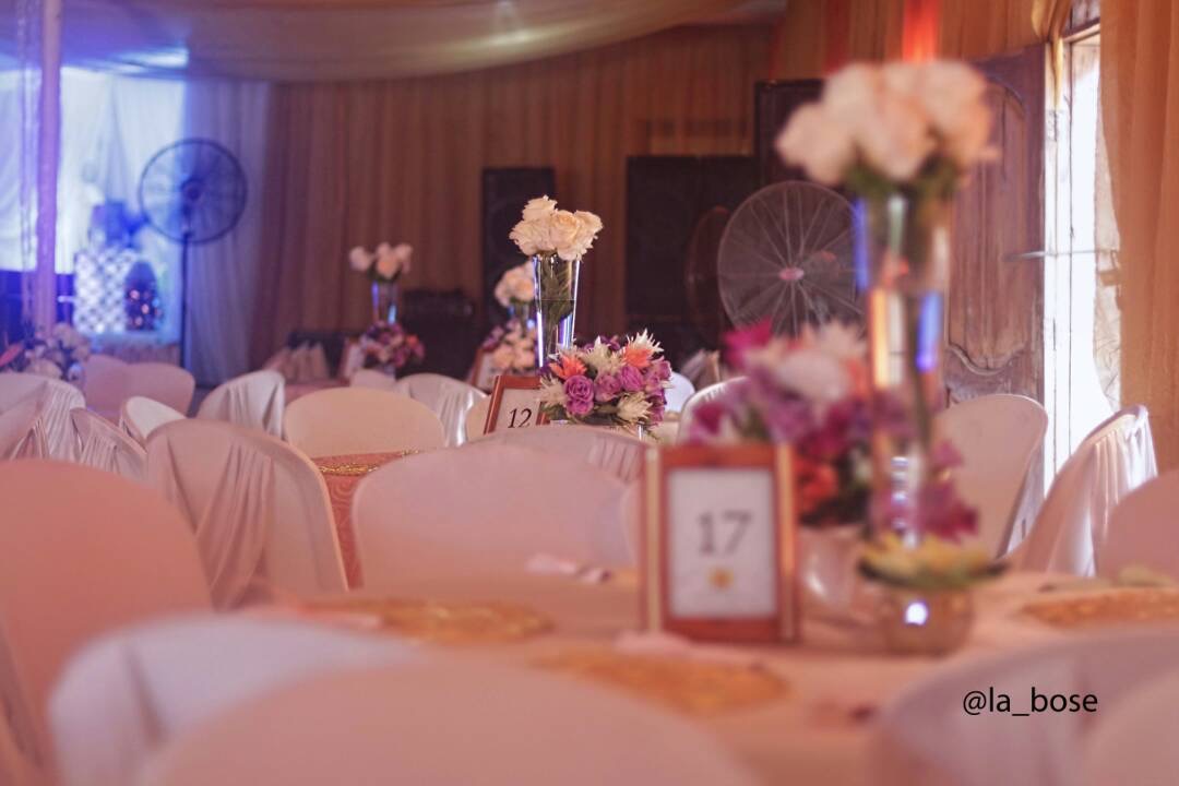 Stylist arranging florals on a luxury table setting