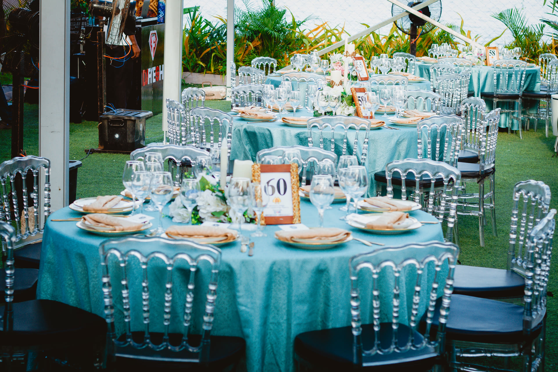 Grand wedding reception hall with gold chiavari chairs and floral centerpieces in Lagos, Nigeria