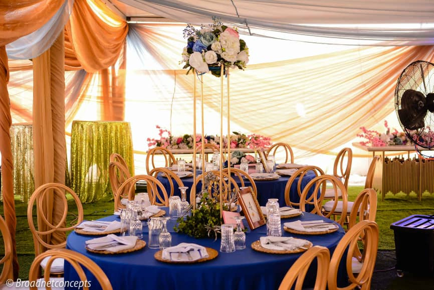 Royal blue outdoor wedding tent with elegant table settings, Lagos Nigeria