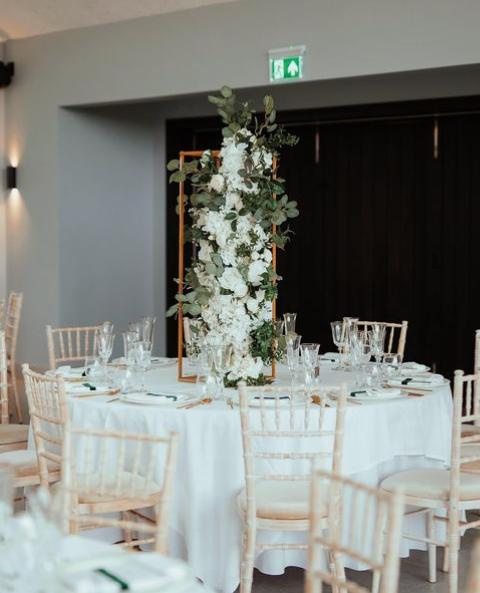 White floral centerpieces with gold chiavari chairs at a luxury Lagos wedding