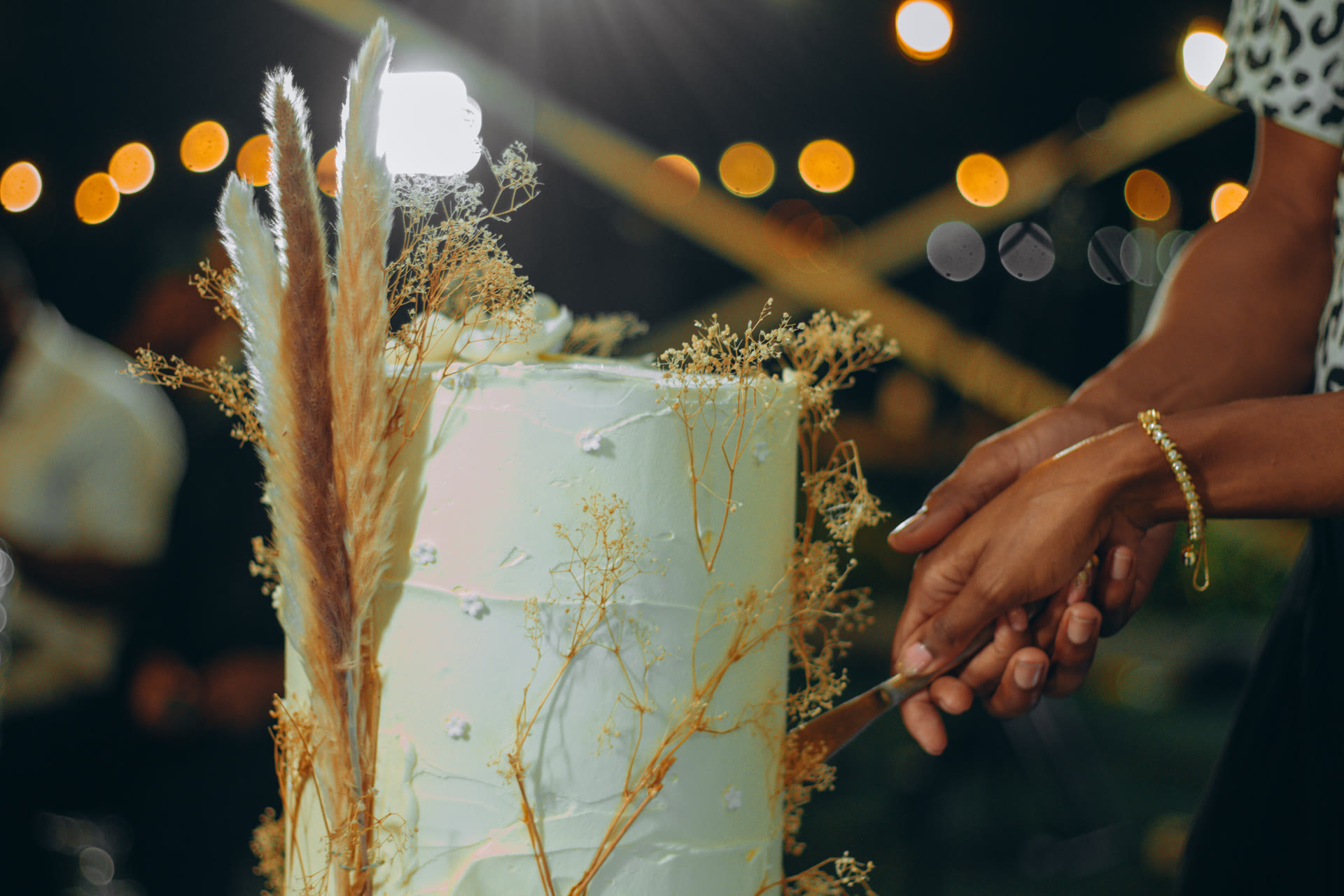 Bride and groom cutting a tiered wedding cake at a Lagos wedding reception decorated by 2A'S Events